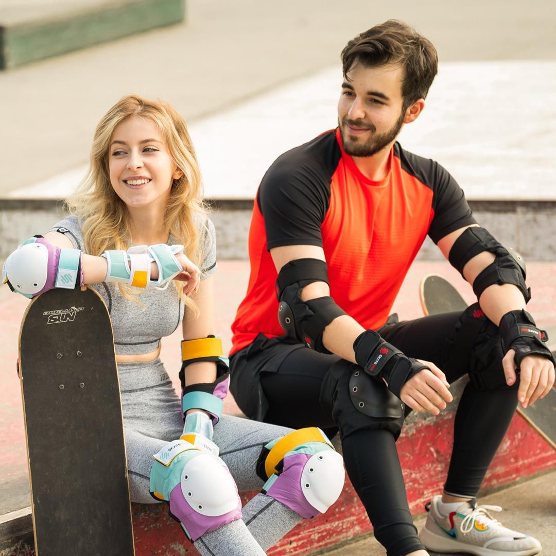 Two skaters at the skatepark laughing in SKATEWIZ protective sets
